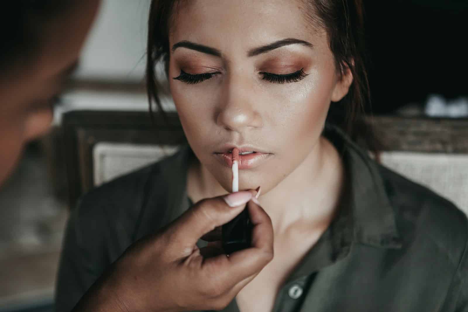 glowing makeup, woman and man near white wall