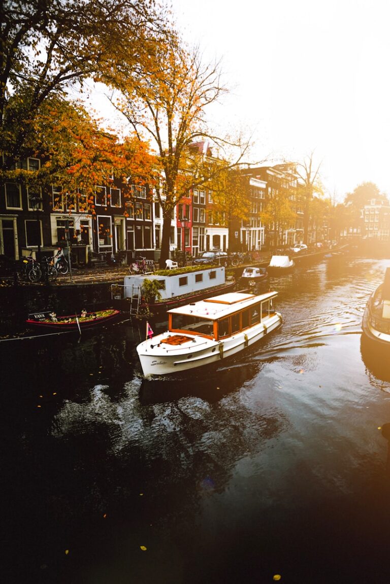 Amsterdam, white boat on body of water near buildings during daytime, Amsterdam