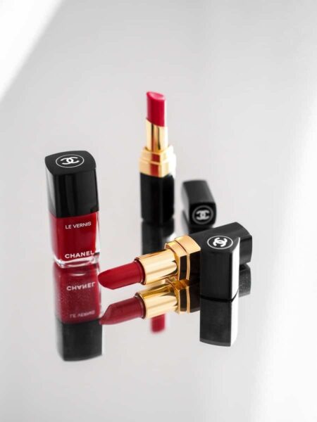 Chanel red and black lipstick beside red lipstick, Chanel