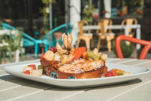 a white plate topped with a piece of toast covered in fruit Cinnamon Baked French Toast
