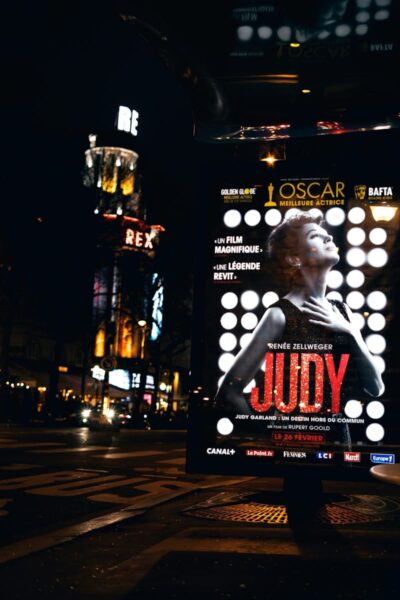oscars 2024 woman in black and white polka dot dress standing on the street