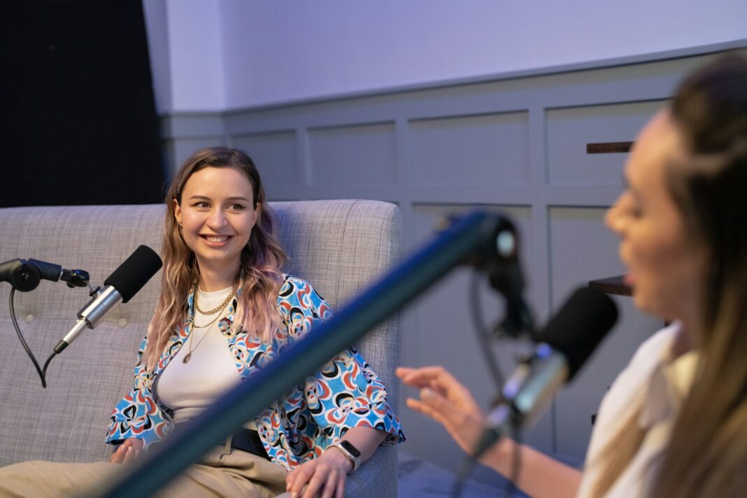 a woman speaking into a microphone, podcast