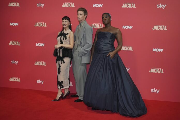 From left, Spanish actress Ursula Corbero, British actor Eddie Redmayne and British actress Lashana Lynch pose for photos on the red carpet at the "The Day of the Jackal" premiere in London, Tuesday, Oct. 22, 2024. (AP Photo/Kin Cheung)