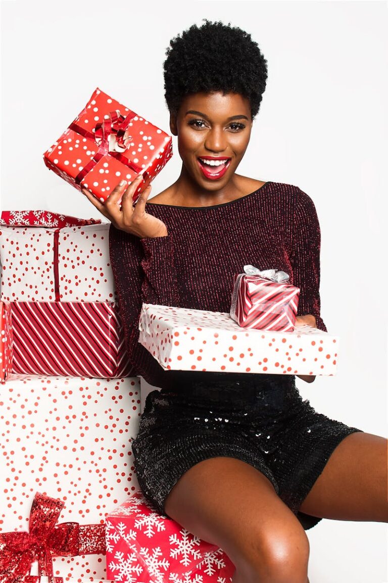 Joyful African American woman with Christmas presents, expressing excitement and holiday cheer.