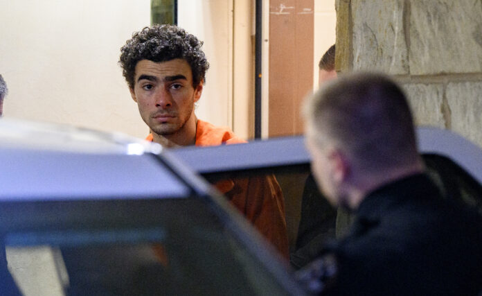 HOLLIDAYSBURG, PENNSYLVANIA - DECEMBER 10: Suspected shooter Luigi Mangione is led from the Blair County Courthouse after an extradition hearing December 10, 2024 in Hollidaysburg, Pennsylvania. Mangione has been arraigned on weapons and false identification charges related to the fatal shooting of United Healthcare CEO Brian Thompson in New York City. Mangione is incarcerated in the State Correctional Institution in Huntingdon, Pennsylvania awaiting extradition to New York. (Photo by Jeff Swensen/Getty Images)
