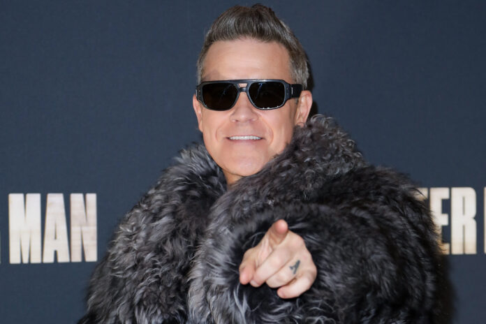 PARIS, FRANCE - DECEMBER 13: Robbie Williams attends the "Better Man" Paris Premiere at the Le Grand Rex on December 13, 2024 in Paris, France. (Photo by Antoine Flament/Getty Images)