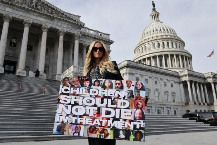 WASHINGTON, DC - DECEMBER 17: Celebrity hotel heiress Paris Hilton poses for photographs outside the U.S. Capitol on the day the House of Representatives is set to vote on The Stop Institutional Child Abuse Act on December 17, 2024 in Washington, DC. Citing her own traumatizing experience at Provo Canyon School in Utah when she was a teenager, Hilton has lobbied for three years for the legislations that would place greater federal safeguards on institutional youth treatment programs. (Photo by Chip Somodevilla/Getty Images)