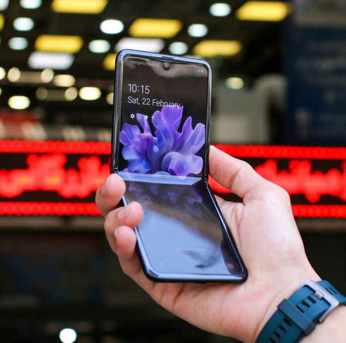 person holding black samsung android smartphone, foldable phone
