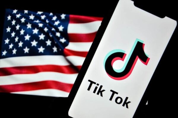 TUNIS, TUNISIA - DECEMBER 08: In this photo illustration, the Tiktok LOGO and the US flag are pictured on December 8, 2024, in Tunis, Tunisia. (Photo by Hasan Mrad/DeFodi Images News)