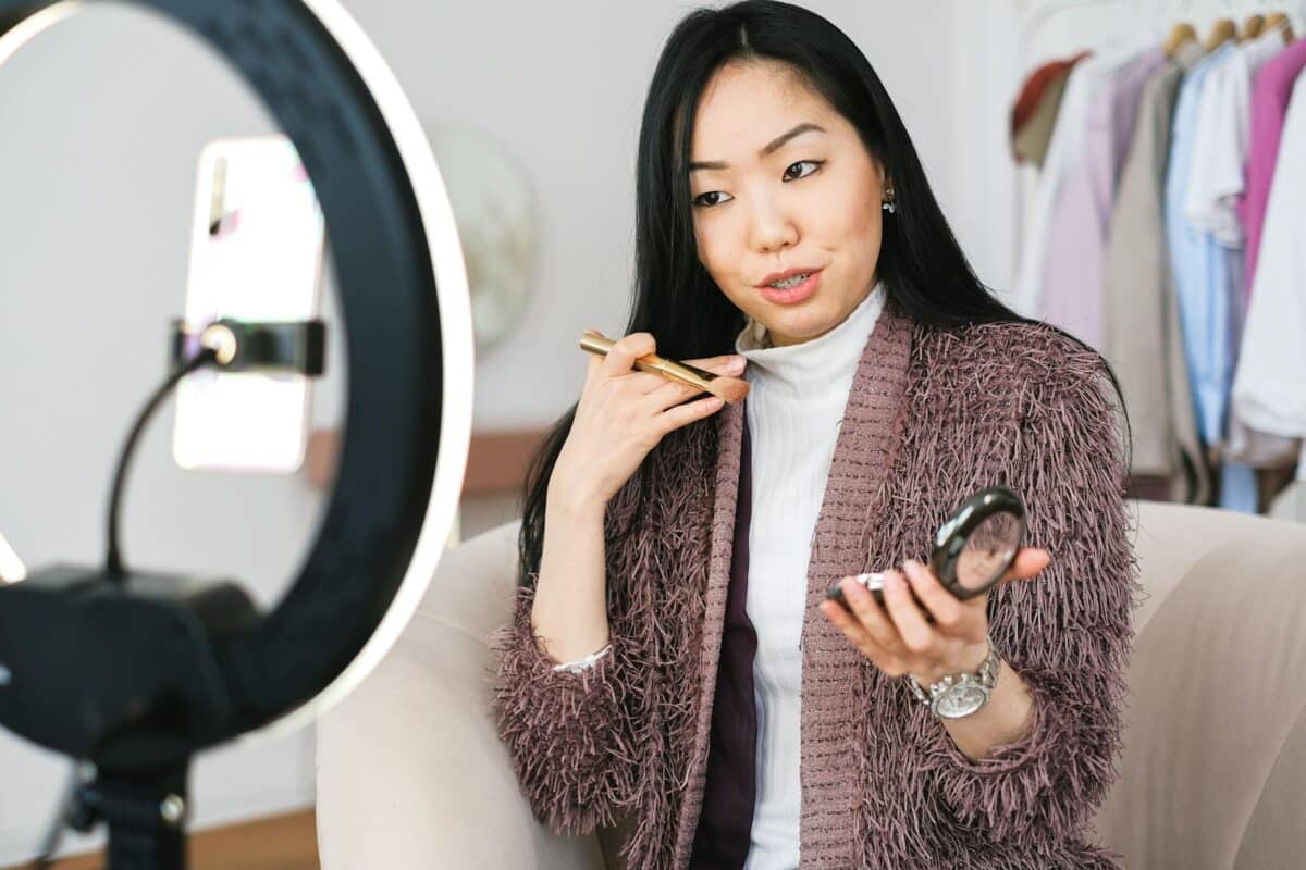 10 Tips Build a Personal Brand - Beauty vlogger demonstrating makeup tips using a ring light during live stream.
