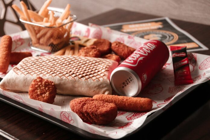 10 Reasons Why Processed Food - red and white coca cola can beside brown bread on white ceramic plate
