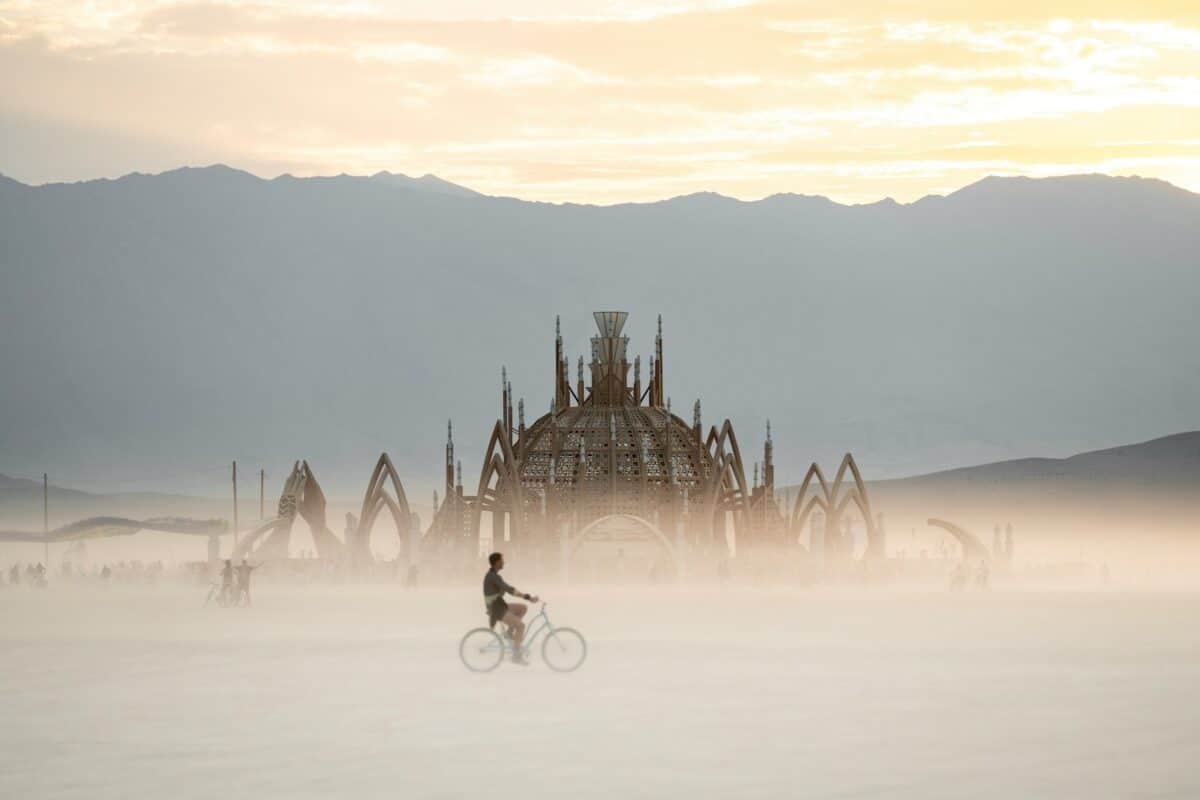 Burning Man Festival - A person riding a bike on a foggy day