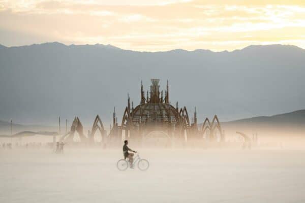 Burning Man Festival - A person riding a bike on a foggy day