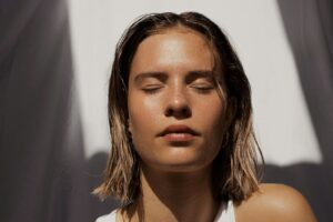 8 Tips to Immediately Soothe Your Sensitive Skin - woman in white tank top