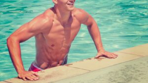 5 Tips to Lose Man Boobs - man holding concrete floor