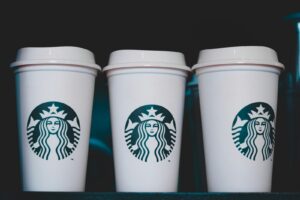 Starbucks Protein Lattes - two white starbucks disposable cups