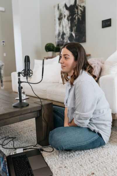 launch, woman in white long sleeve shirt and blue denim jeans sitting on white couch