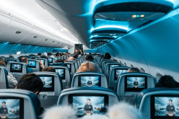 movies while on a plane - people in airplane during daytime