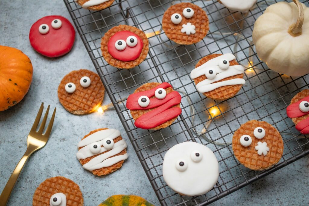 Trick-or-Treating, ha table topped with lots of cookies covered in icing