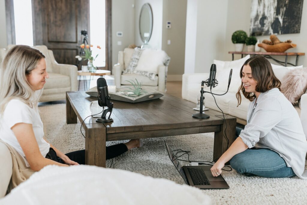 hosted, person in white shirt using black laptop computer on brown wooden table