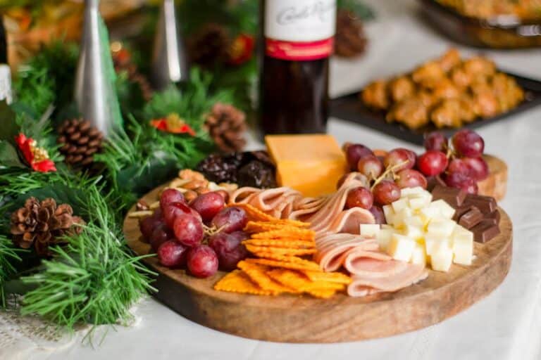 Christmas Party Delicious charcuterie board with assorted cheese, meats, grapes, and crackers, perfect for festive gatherings.