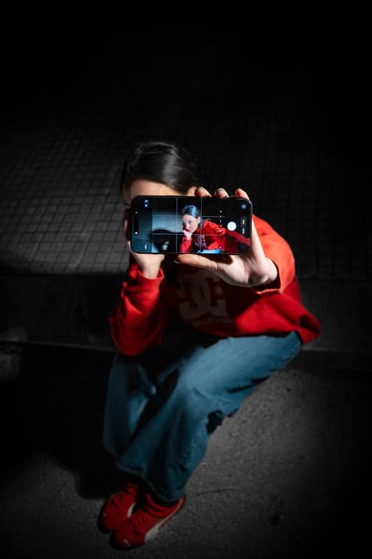 Editorial Standards & Ethics  - Person taking a selfie with a smartphone