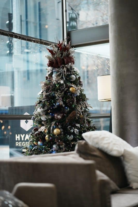A decorated christmas tree in a modern lobby