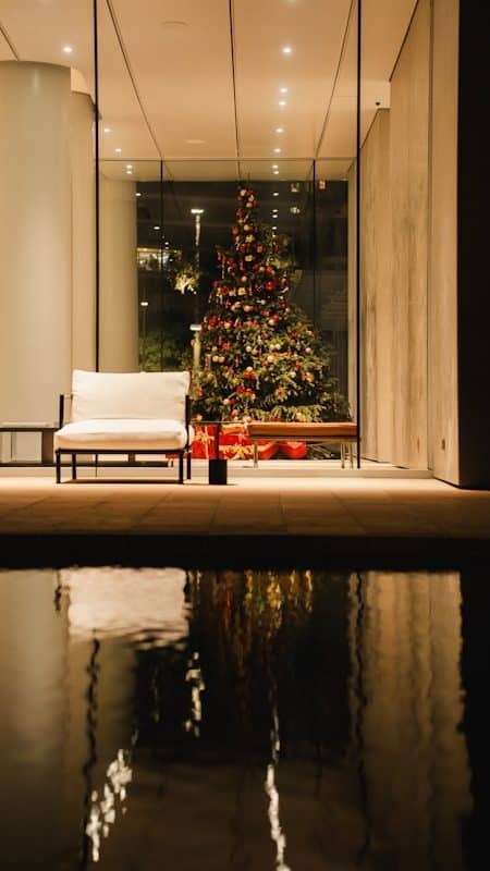 Decorated christmas tree reflected in water