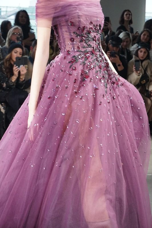 Valentino Garavani: Designer Who Loved Women A model wears a sparkling purple gown with floral embellishments