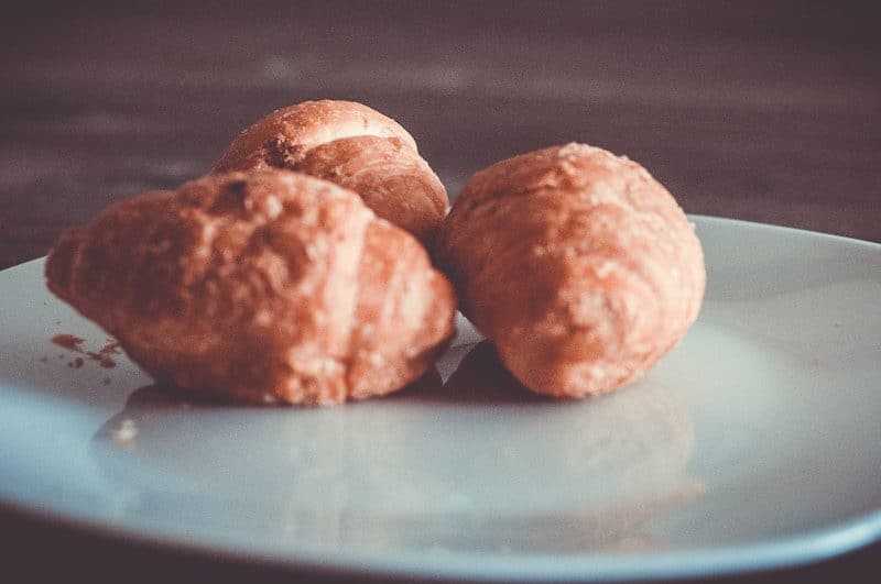 three brown breads on white ceramic plate