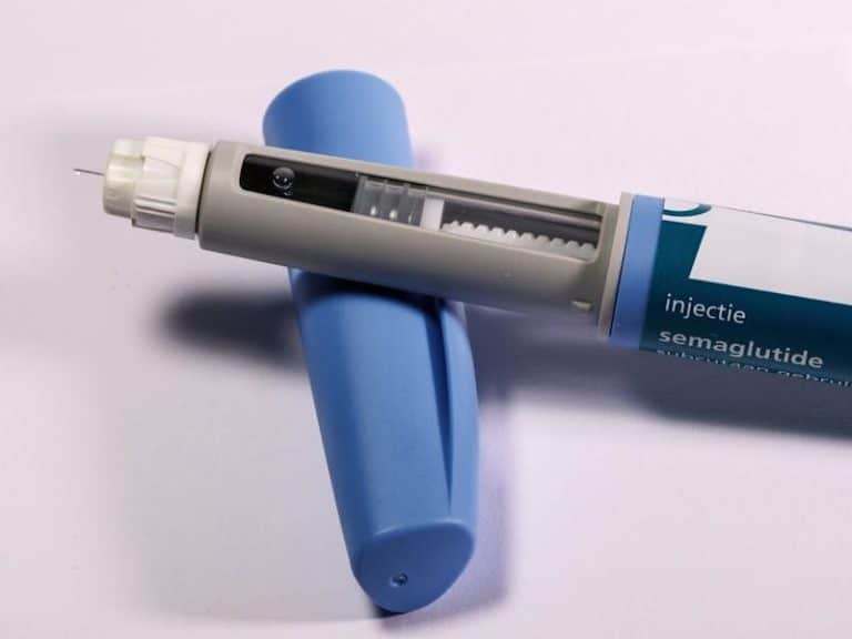 GLP-1 medications - Detailed view of a semaglutide injection pen, commonly used for diabetes treatment, on a plain background.