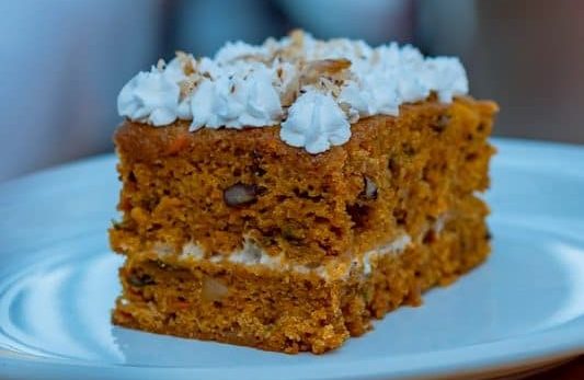 Pumpkin Spice Texas Sheet Cake - a piece of cake sitting on top of a white plate