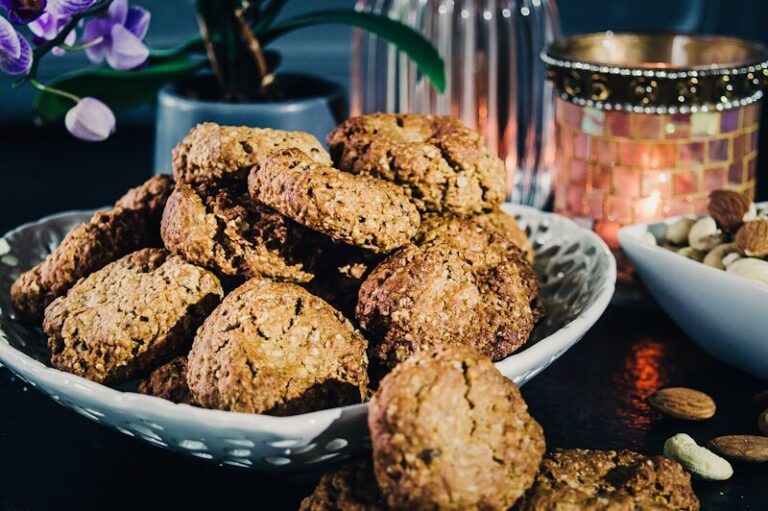 Brown Sugar Oatmeal Cookies a plate full of cookies next to a bowl of nuts