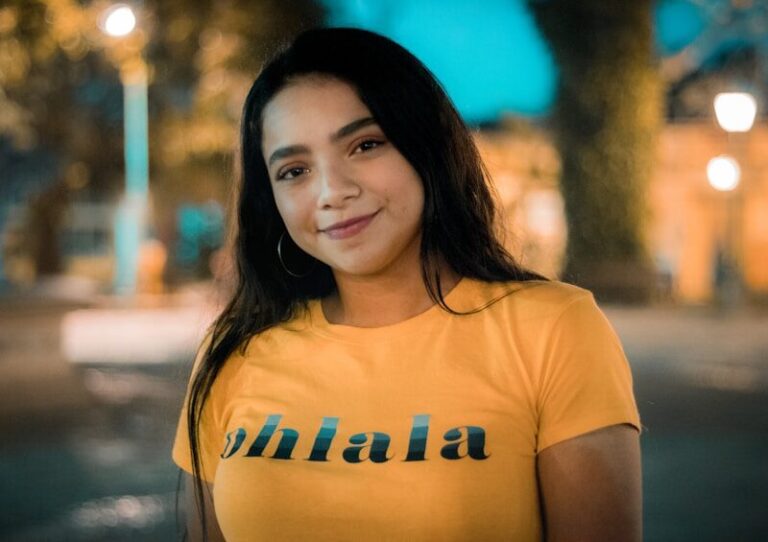WEF: AI Threatens 58% of Women's Jobs by 2030 , smiling woman in orange crew-neck t-shirt